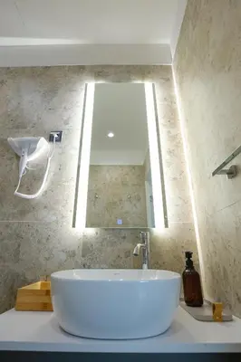 a bathroom with a large white sink and a mirror at Simma Luxury Apartments & Rooms in Belgrade