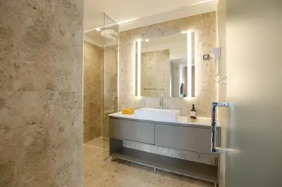 a bathroom with a sink and a mirror at Simma Luxury Apartments & Rooms in Belgrade