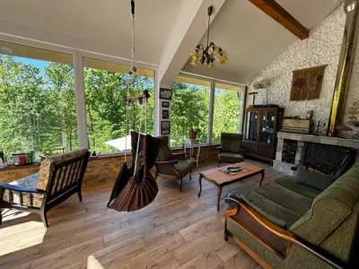 a living room with a couch and a fireplace at Šumska Vila Lipovica in Barajevo