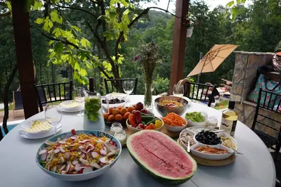 a table with a bunch of food on it at Šumska Vila Lipovica in Barajevo