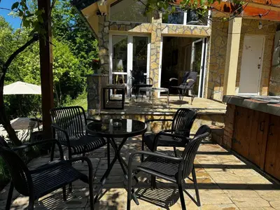 a patio with chairs and a table on a patio at Šumska Vila Lipovica in Barajevo