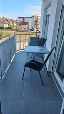 a balcony with a table and chairs on a balcony at Popovic in Ub