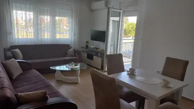 a living room with a couch and a table at Popovic in Ub