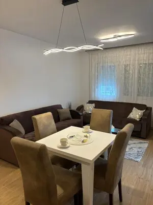 a living room with a table and a couch at Popovic in Ub