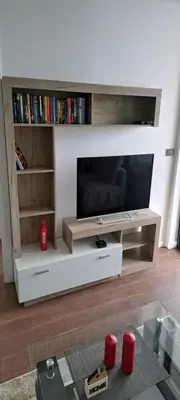 a living room with a large entertainment center with a tv at Kosmaj Renew - Sunset View in Koraćica
