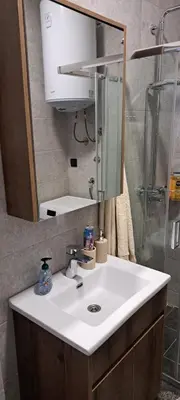 a bathroom with a white sink and a shower at Kosmaj Renew - Sunset View in Koraćica