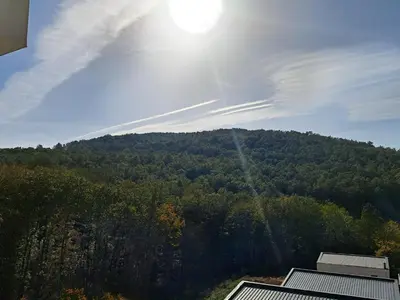 a view of a mountain with the sun in the sky at Kosmaj Renew - Sunset View in Koraćica