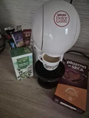 a coffee maker with a cup of coffee and other products at Kutak na Lekinom brdu in Vračar (historical)
