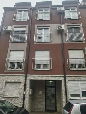 a tall building with windows and balconies on it at Kutak na Lekinom brdu in Vračar (historical)