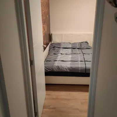 a small bedroom with a bed in a small room at Kutak na Lekinom brdu in Vračar (historical)