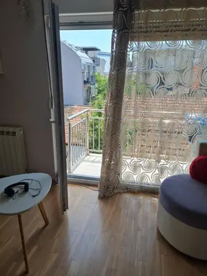 a room with a door open to a balcony at Kutak na Lekinom brdu in Vračar (historical)