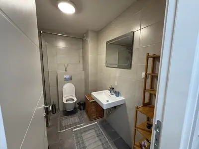 a small bathroom with a sink and a toilet at Apartman Lukač in Belgrade