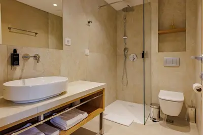 a bathroom with a sink and a shower at Hotel HOGO in Inđija