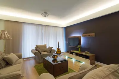 a living room with a couch and a tv at Apartment Mercedes in Belgrade