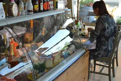 a woman standing at a counter in a store at Apartment Mercedes in Belgrade