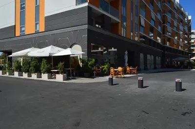 a building with tables and chairs and umbrellas at Apartment Mercedes in Belgrade