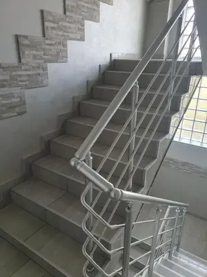 a set of stairs with a metal railing at Small cute single room A2 in Pancevo in Pančevo