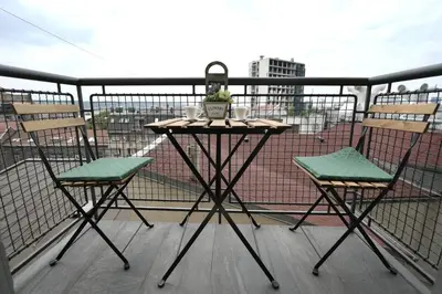 a table and two chairs on a balcony at Prime City Center Apartment - Walk to All Attractions in Belgrade