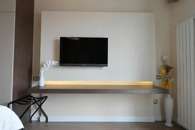a flat screen tv on a wall with a shelf at Prime City Center Apartment - Walk to All Attractions in Belgrade