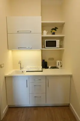 a kitchen with a sink and a microwave at Prime City Center Apartment - Walk to All Attractions in Belgrade
