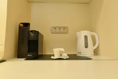 a kitchen counter with a coffee maker and a coffee pot at Prime City Center Apartment - Walk to All Attractions in Belgrade
