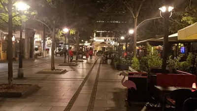 a street at night with people walking down the street at Prime City Center Apartment - Walk to All Attractions in Belgrade