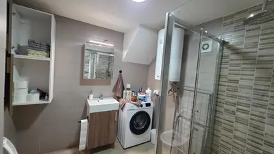 a bathroom with a washing machine and a sink at Duplex stan u Beogradu in Belgrade