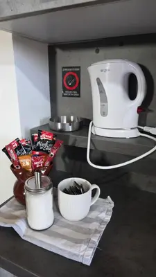 a kitchen counter with a mixer and a cup of coffee at Duplex stan u Beogradu in Belgrade