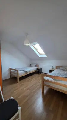 a room with two beds and a skylight at Duplex stan u Beogradu in Belgrade