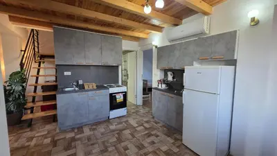 a kitchen with a white refrigerator and a stove at Duplex stan u Beogradu in Belgrade