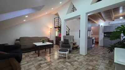 a living room with a couch and a table at Duplex stan u Beogradu in Belgrade
