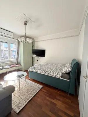 a small bedroom with a bed and a table at Apartment A3, Center, Belgrade in Belgrade