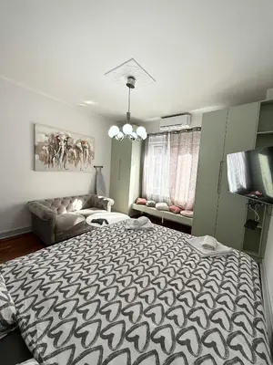 a bedroom with a large bed and a couch at Apartment A3, Center, Belgrade in Belgrade