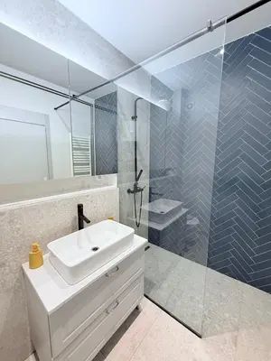 a bathroom with a sink and a glass shower at Apartment A3, Center, Belgrade in Belgrade