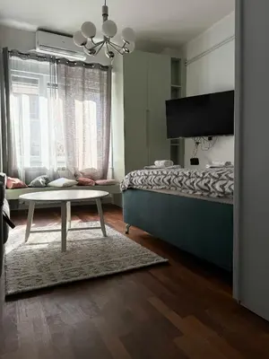 a bedroom with a bed and a table in it at Apartment A3, Center, Belgrade in Belgrade