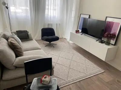a living room with a couch and a flat screen tv at Fin apartman in Zvezdara