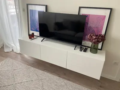 a flat screen tv sitting on a white entertainment center at Fin apartman in Zvezdara
