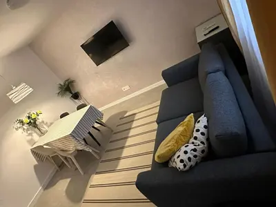 a living room with a blue couch and a table at Apartman Dorćol VS60 in Belgrade