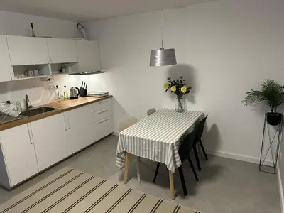 a kitchen with a table with a vase of flowers on it at Apartman Dorćol VS60 in Belgrade