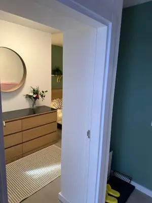 a room with a mirror and a dresser with yellow shoes at Apartman Dorćol VS60 in Belgrade