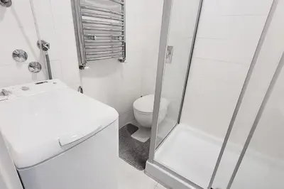 a white bathroom with a toilet and a shower at All you need is just around the corner in Belgrade