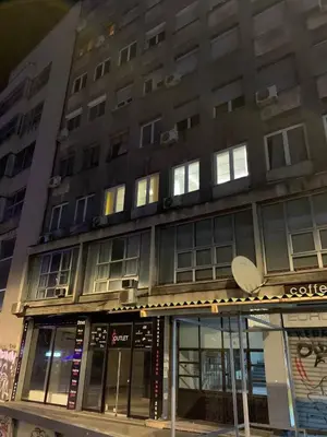 a tall building with windows on the side of it at All you need is just around the corner in Belgrade