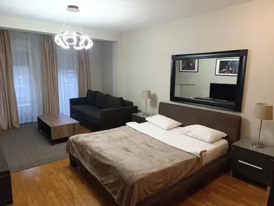 a bedroom with a bed and a living room at Moka in Belgrade