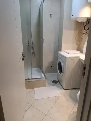 a bathroom with a shower and a washing machine at Moka in Belgrade