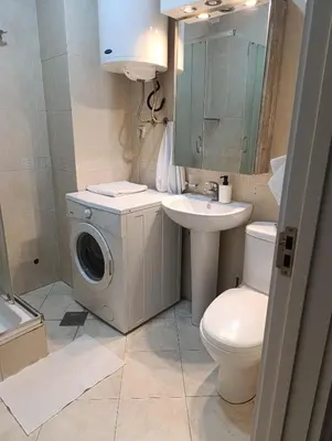 a bathroom with a washing machine and a washer at Moka in Belgrade