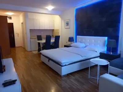 a bedroom with a bed and a table and chairs at Kiki in Belgrade