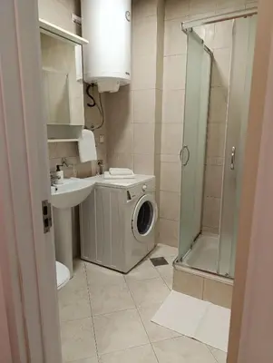 a bathroom with a washing machine and a sink at Kiki in Belgrade