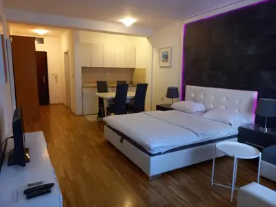 a bedroom with a bed and a table and chairs at Kiki in Belgrade