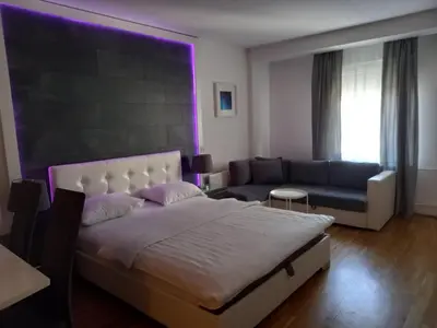a bedroom with a bed and a couch at Kiki in Belgrade