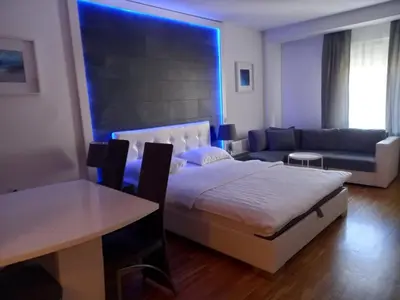 a bedroom with a bed and a couch and a table at Kiki in Belgrade